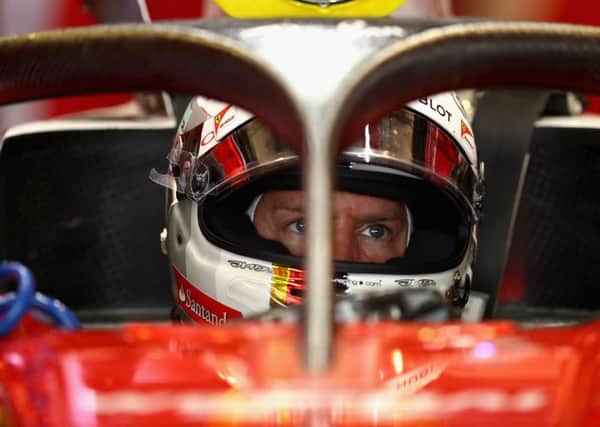 Sebastian Vettel sits in his Ferrari fitted with the cockpit safety device known as the halo. Picture: Getty.