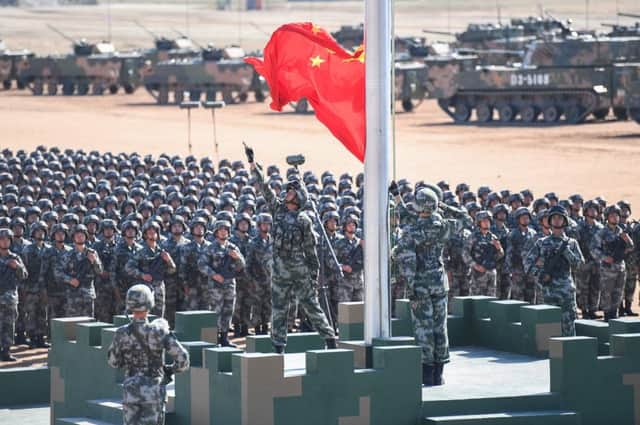 The Chinese flag is raised during a military parade at the Zhurihe training base in China's northern Inner Mongolia region. Picture: China OUTSTR/AFP/Getty Images