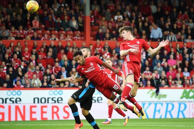 Aberdeen midfielder Ryan Christie rises to steer a header into the Apollon Limassol net. Picture: SNS.