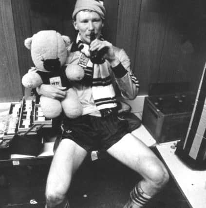 Davie Dodds alone with his thoughts, a mascot bear and a bottle of beer after Dundee United win the league in May 1983.