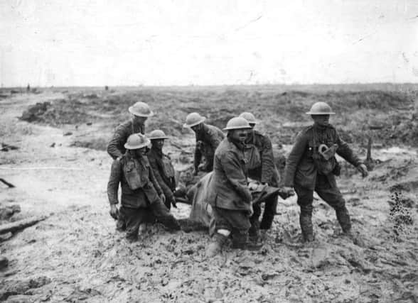 A stretcher-bearing party carrying a wounded soldier through the mud near Boesinghe during the battle of Passchendaele in Flanders.   (Photo by John Warwick Brooke/Getty Images)