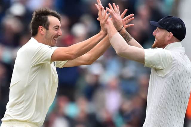 Toby Roland-Jones, left, celebrates with Ben Stokes after dismissing Heino Kuhn. Picture: AFP.