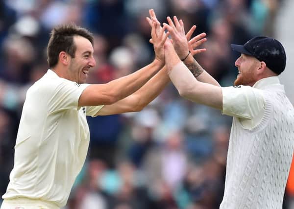 Toby Roland-Jones, left, celebrates with Ben Stokes after dismissing Heino Kuhn. Picture: AFP.