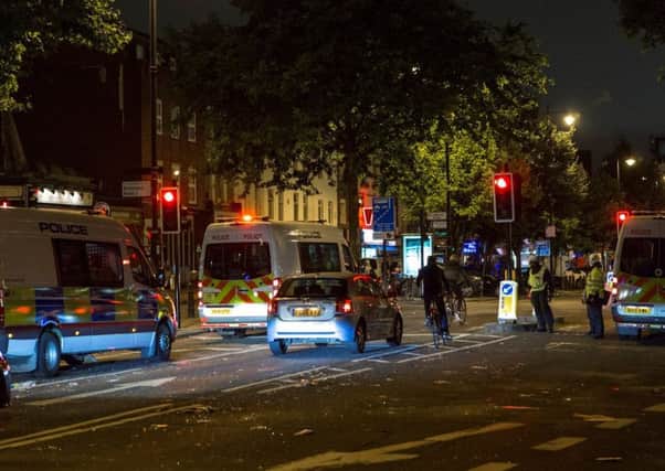 Police take security measures as the streets are trashed following a demonstration demanding justice after the death of Rashan Charles. Picture; Getty