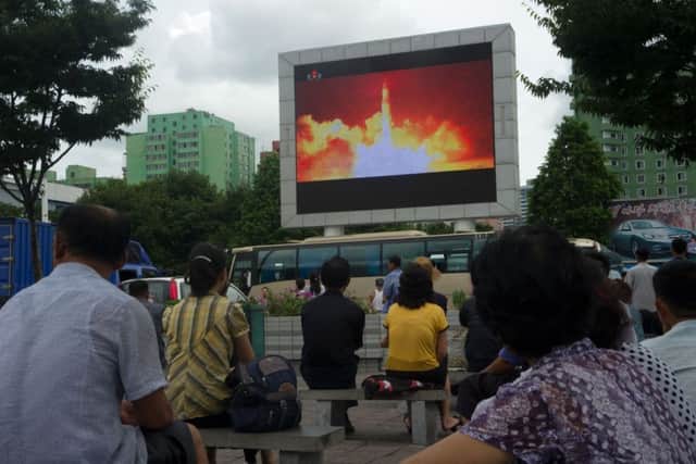 People watch as coverage of an ICBM missile test is displayed on a screen in a public square in Pyongyang on July 29, 2017.
Picture; Getty