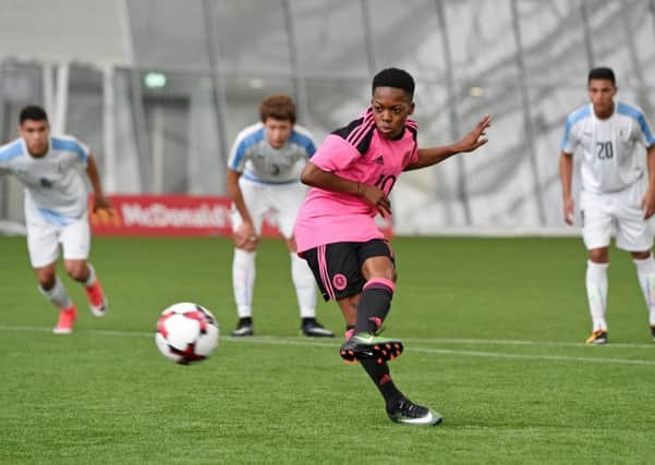 Karamoko Dembele slots home a penalty to make it 2-0 to Scotland. Picture: SNS/Paul Devlin