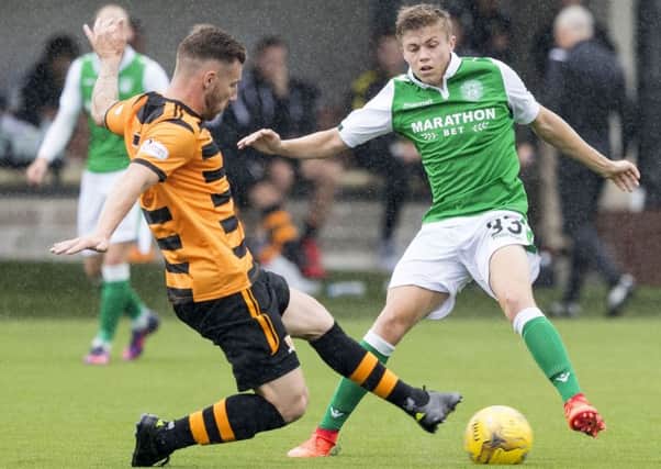 Hibernian's Fraser Murray is tackled by Alloa's Kevin Cawley. Picture: SNS/Alan Rennie