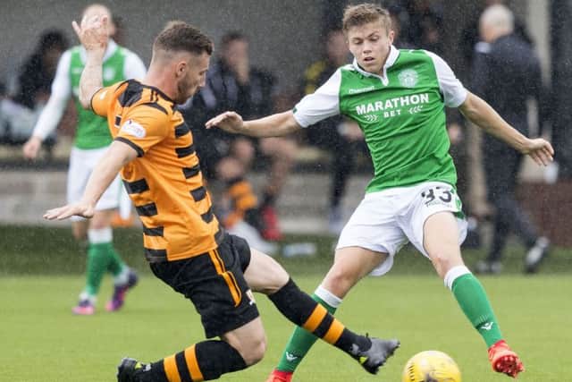 Hibernian's Fraser Murray is tackled by Alloa's Kevin Cawley. Picture: SNS/Alan Rennie