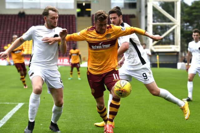 Motherwell's Elliott Frear takes on Berwick's Darren Laverty (left). Picture: SNS/Rob Casey