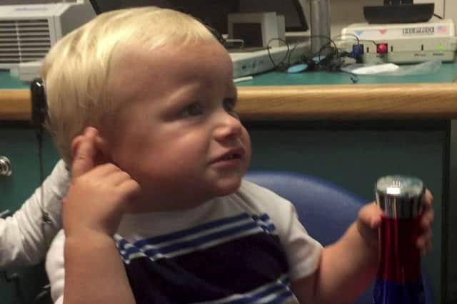 Kanon Newsome hears through his cochlear implant for the first time. Picture: SWNS