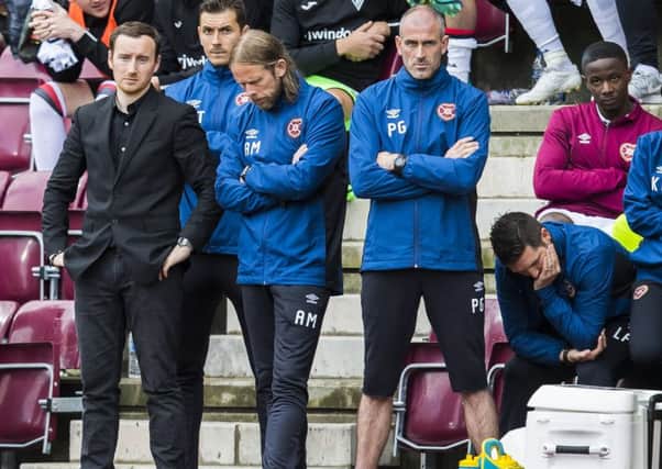 The expressions of Hearts head coach Ian Cathro (left) with Austin MacPhee (centre) and Paul Gallacher reflect the grim mood at Tynecastle on Saturday. Picture: SNS.