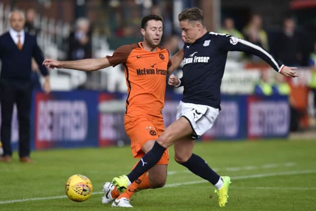Dundee Utd's Lewis Toshney (left) battles for the ball with Scott Allan. Picture: SNS/Rob Casey