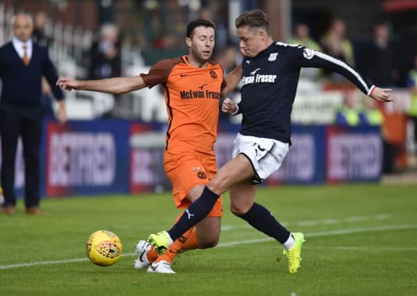 Dundee Utd's Lewis Toshney (left) battles for the ball with Scott Allan. Picture: SNS/Rob Casey
