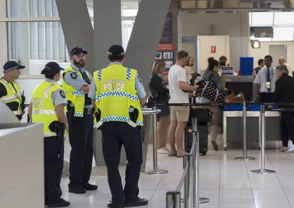 Police guard the passenger security check area at Sydney Airport. Picture: Brook Mitchell/Getty Images