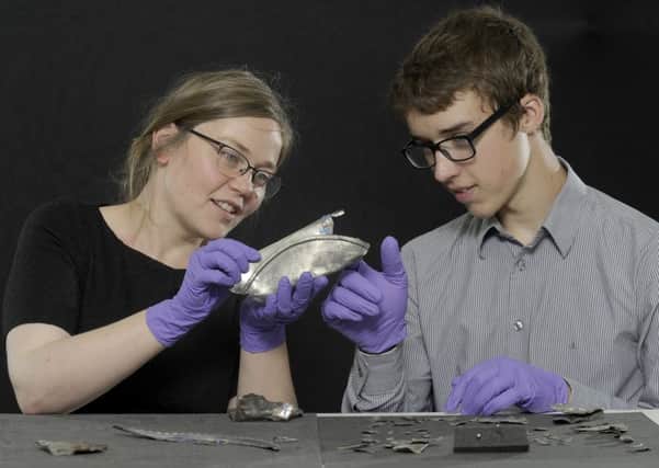 David Hall examines the Roman era silver he unearthed with Alice Blackwell of National Museums Scotland. Picture: Neil Hanna