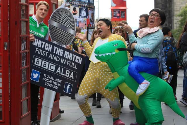 New Hibs midfielder Vykintas Slivka bumps into the Edinburgh Festival Fringe show Toy on the High Street. Picture: Stewart Attwood