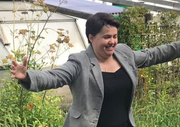 Ruth Davidson runs through a field of wheat