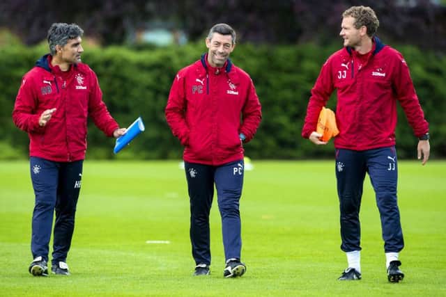 Pedro Caixinha, centre, with assistants Helder Baptista, left, and Jonatan Johansson at training. Picture: SNS