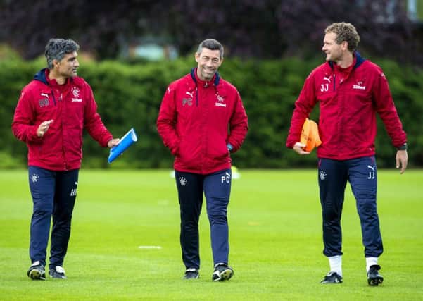 Pedro Caixinha, centre, with assistants Helder Baptista, left, and Jonatan Johansson at training. Picture: SNS