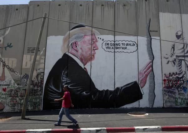 A mural resembling the work of elusive artist Banksy depicting President Donald Trump wearing a Jewish skullcap. Picture: AP Photo/Nasser Nasser