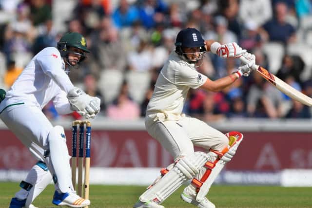Joe Root cuts a ball to pick up some runs watched by Quinton de Kock. Picture: Getty.