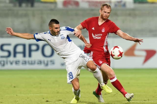 Mark Reynolds battles with Apollon Limassols Anton Maglica during Aberdeens defeat in Cyprus. Photograph: Craig Foy/SNS