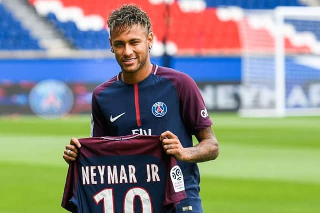Brazilian superstar Neymar poses with his new Paris Saint Germain jersey following his world record 222 million euro transfer from Barcelona. Picture: Lionel Bonaventure/AFP/Getty Images