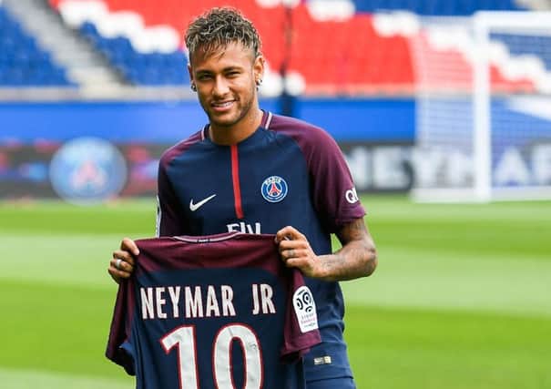 Brazilian superstar Neymar poses with his new Paris Saint Germain jersey following his world record 222 million euro transfer from Barcelona. Picture: Lionel Bonaventure/AFP/Getty Images