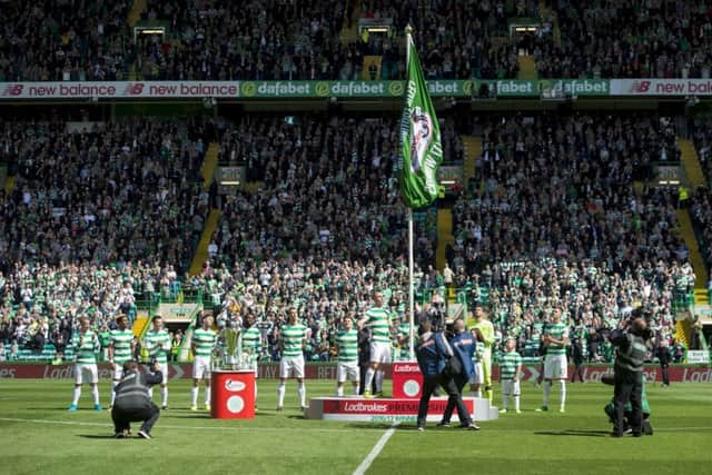 Celtic captain Scott Brown unfurls the Ladbrokes Champions flag before the match against Hearts. Picture: SNS/Craig Foy