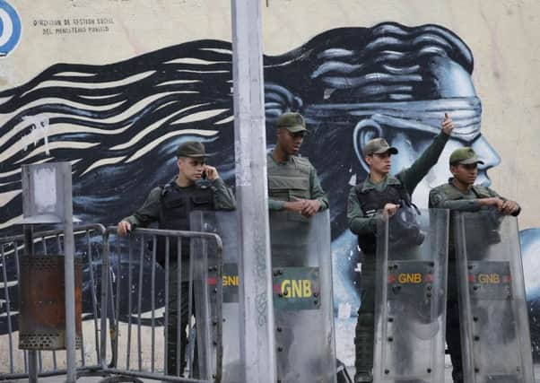 Guards with riot shields stand outside chief prosecutor Luisa Ortegas office. Picture: AP