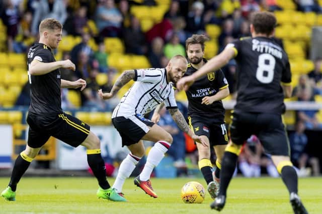Dunfermline's Kallum Higginbotham in action against Alan Lithgow (left). Picture: SNS/Alan Rennie