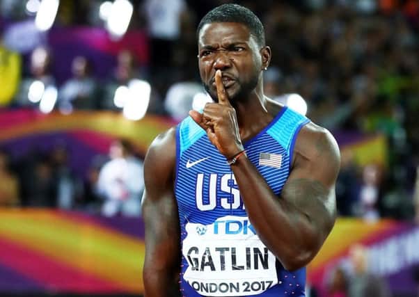 Justin Gatlin raises a finger to his lips to silence the crowd's boos after he beat Usain Bolt into third place in the Men's 100 metres final. Picture: Michael Steele/Getty Images