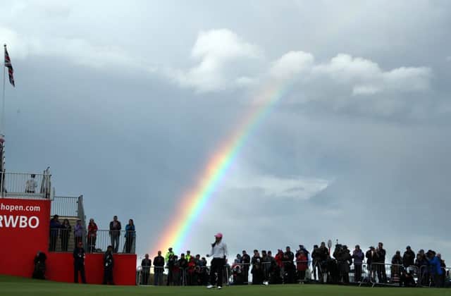 In-Kyung Kim holes her par putt on the 18th green as a raoinbow forms behind the crowds during the third round of the Ricoh Women's British Open at Kingsbarns. Picture: Getty Images