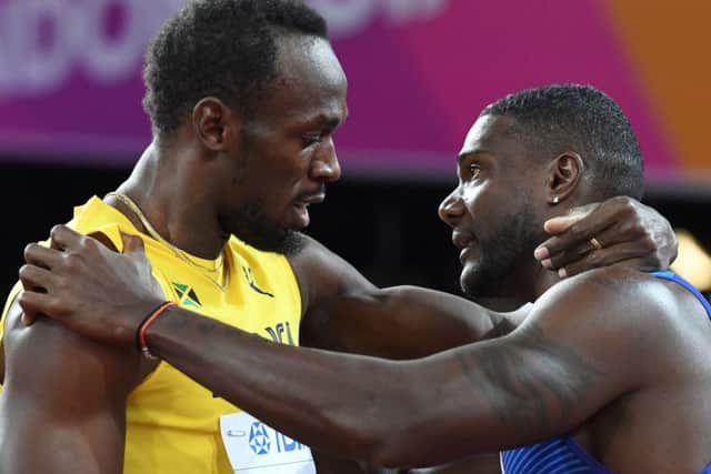 Justin Gatlin, right, embraces Usain Bolt after winning the final of the men's 100m at the world championships. Picture: Kirill Kudryavtsev/AFP/Getty Images