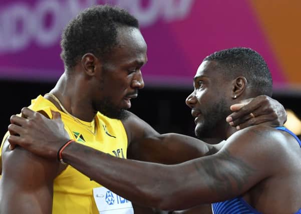 Justin Gatlin, right, embraces Usain Bolt after winning the final of the men's 100m at the world championships. Picture: Kirill Kudryavtsev/AFP/Getty Images