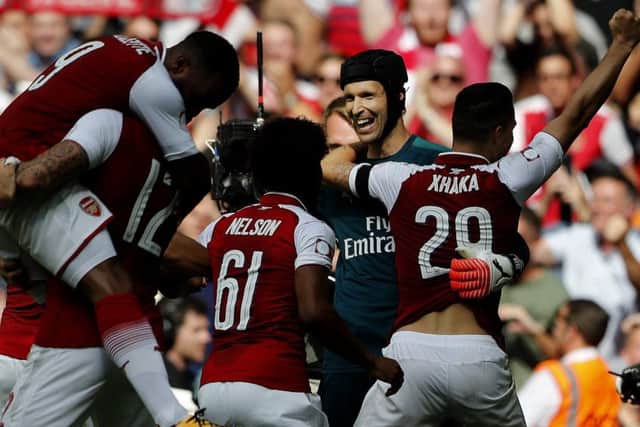 Arsenal striker Olivier Giroud, second from left, celebrates after scoring the decisive penalty to win the Community Shield. Picture: AP.