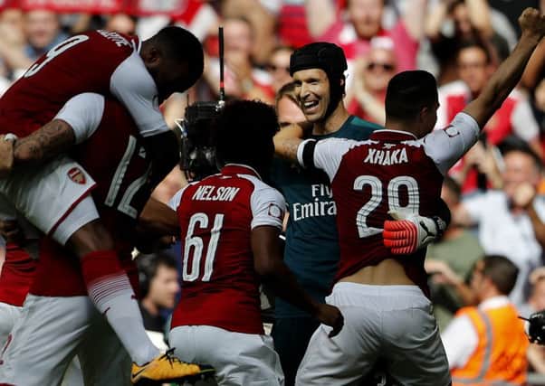 Arsenal striker Olivier Giroud, second from left, celebrates after scoring the decisive penalty to win the Community Shield. Picture: AP.