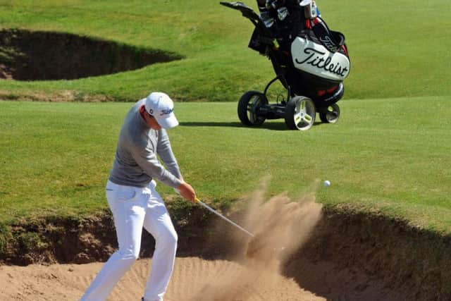 Sam Locke plays out of a bunker on his way to winning the Scottish Amateur title.
