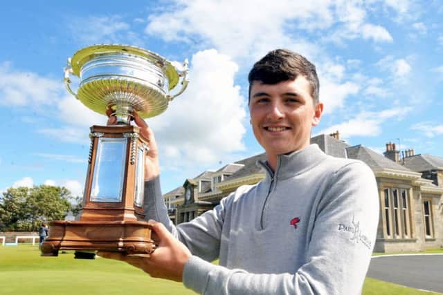Sam Locke shows off the trophy after his victory.