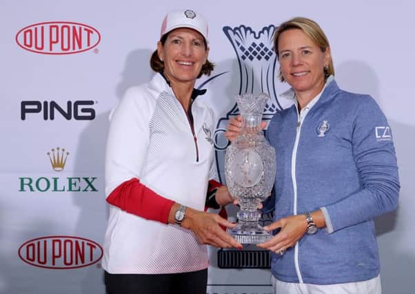 Juli Inkster and Annika Sorenstam pose with the Solheim Cup trophy before naming their teams. Picture: Getty.