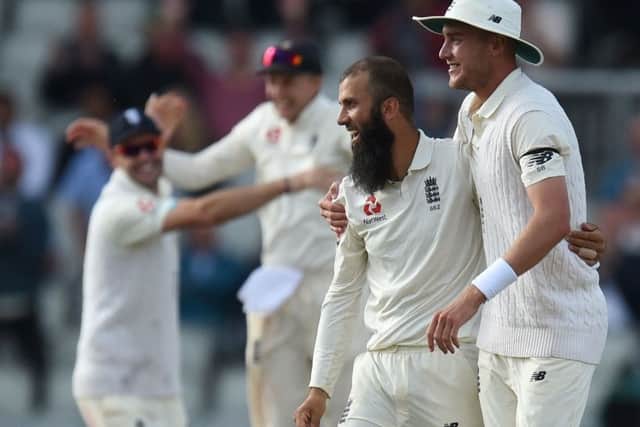 Moeen Ali, left, celebrates with Stuart Broad as England beat South Africa at Old Trafford. Picture: Oli Scarff/AFP/Getty Images