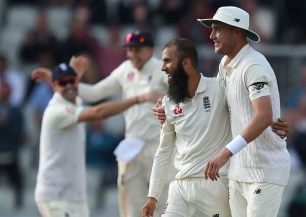 Moeen Ali, left, celebrates with Stuart Broad as England beat South Africa at Old Trafford. Picture: Oli Scarff/AFP/Getty Images