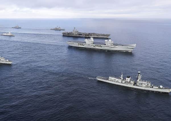 HMS Queen Elizabeth (second right), the Royal Navy's new aircraft carrier, meeting up with a task group of ships taking part in Exercise Saxon Warrior. Picture: LPhot Ioan Roberts/Royal Navy/MoD/Crown
