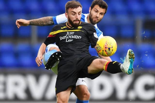 Partick Thistle's Steven Lawless in action with St Johnstone's Richard Foster. Picture: SNS/Bill Murray