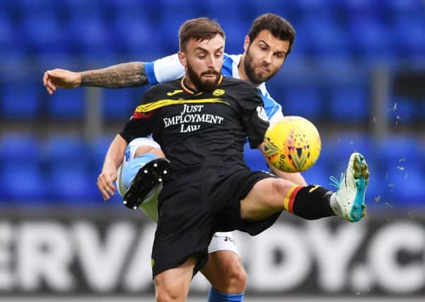 Partick Thistle's Steven Lawless in action with St Johnstone's Richard Foster. Picture: SNS/Bill Murray