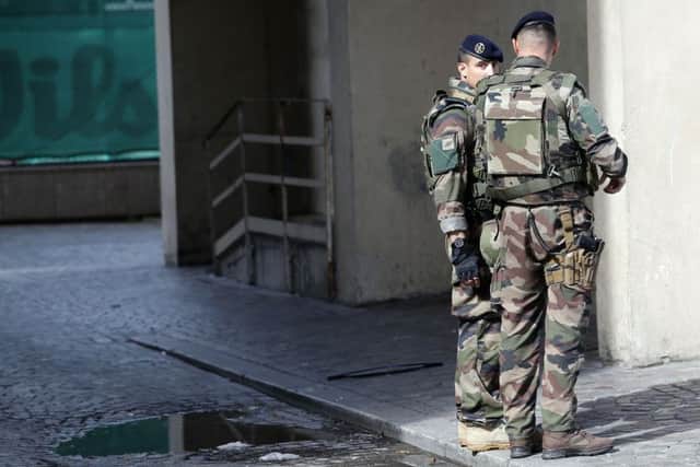 French soldiers stand near the scene where six soldiers were hit by a vehicle in Levallois-Perret. Picture: AP