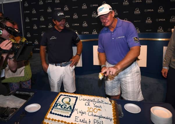 Phil Mickelson and Ernie Els celebrate their 100th major prior to the US PGA Championship at Quail Hollow. Picture: Ross Kinnaird/Getty Images