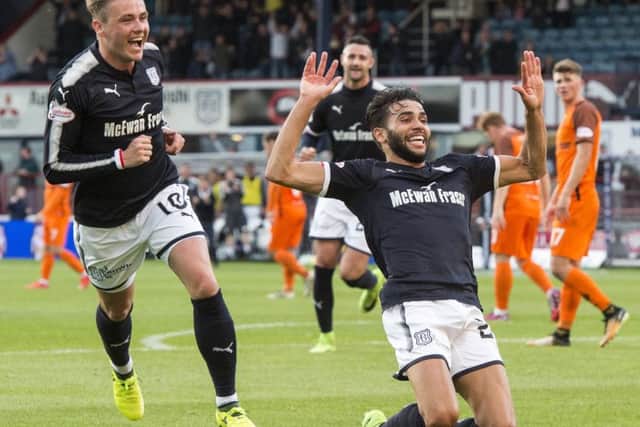 Faissal El Bakhtaoui slides to his knees to celebrate after opening the scoring for Dundee with an unstoppable shot. Picture: SNS