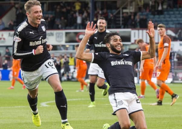 Faissal El Bakhtaoui slides to his knees to celebrate after opening the scoring for Dundee with an unstoppable shot. Picture: SNS