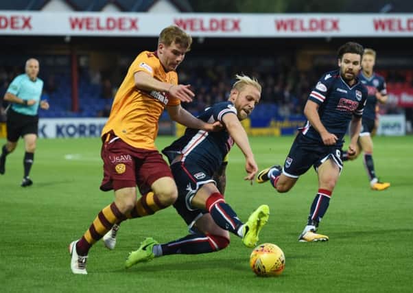 Ross County's Andrew Davies, right, tackles Motherwell's Chris Cadden. Picture: Craig Foy/SNS